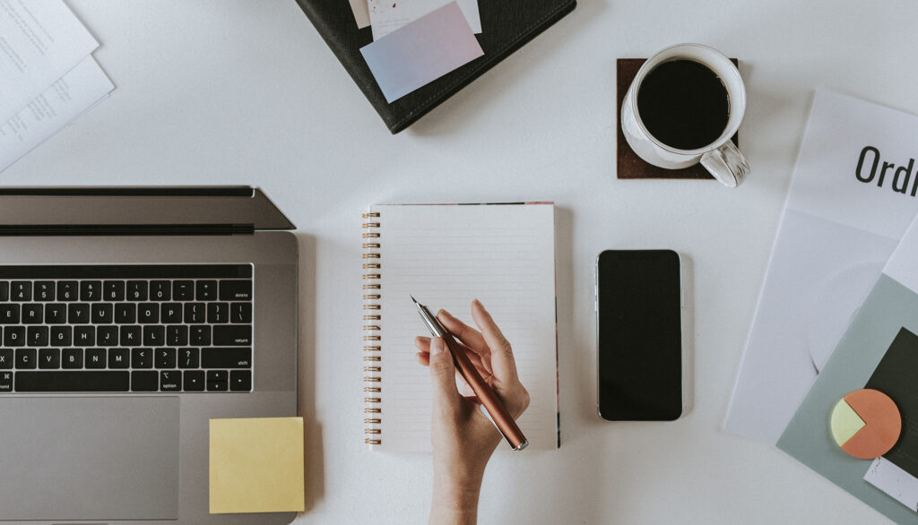 Woman with digital devices writing blog